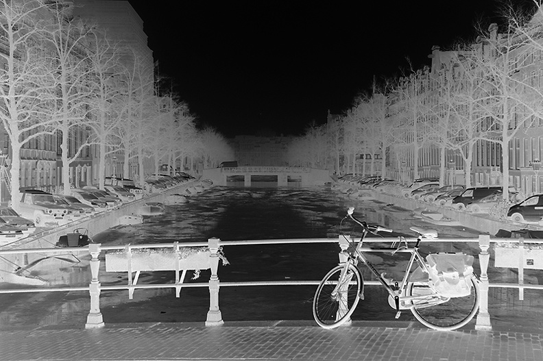 Weather was so dull and gray that even a B&W version wasn't interesting. So I inverted this image of my own bike,  parked on  a bridge on my way to school.