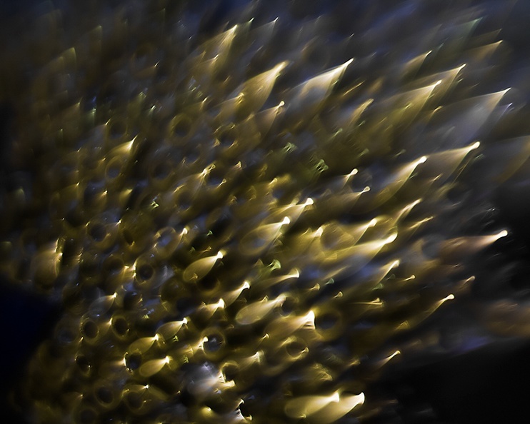 A blurry closeup of a candle of glass