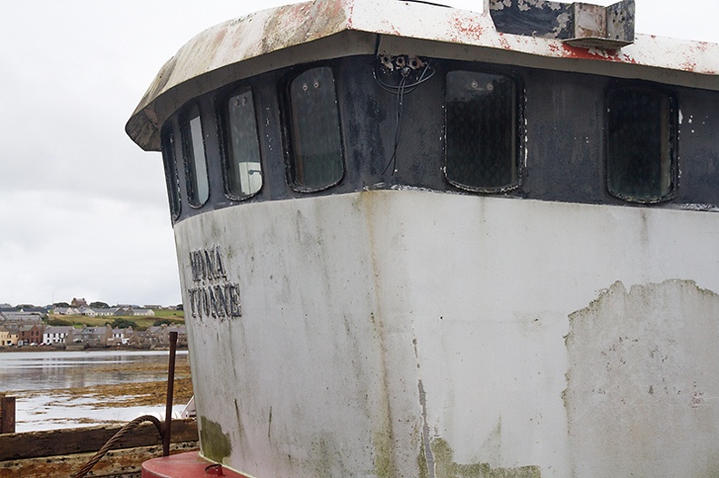 Wheelhouse of what once was a trawler with a glimpse of St. Margeret's Hope