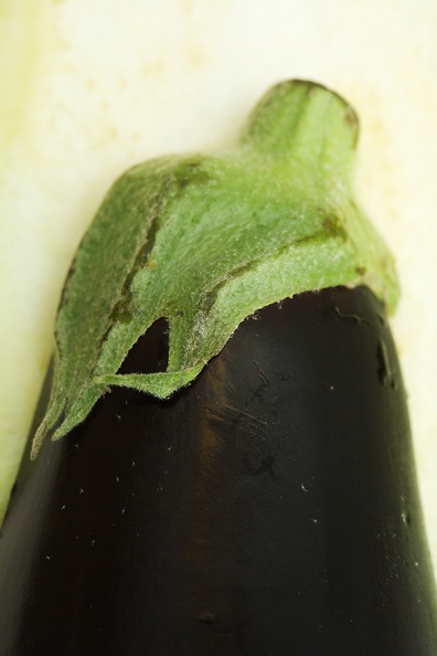Half of an aubergine with a background of the other half