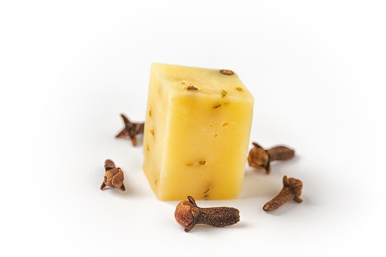 With a piece of clove cheese, also known as 