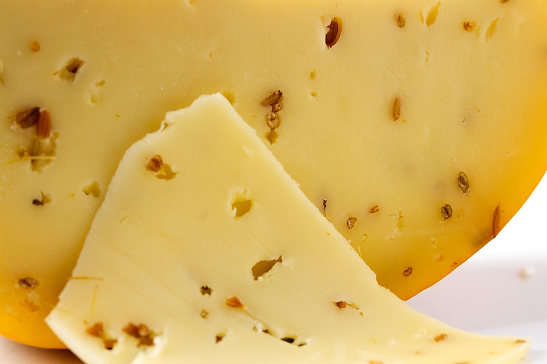 Delicious piece of cheese with cumin