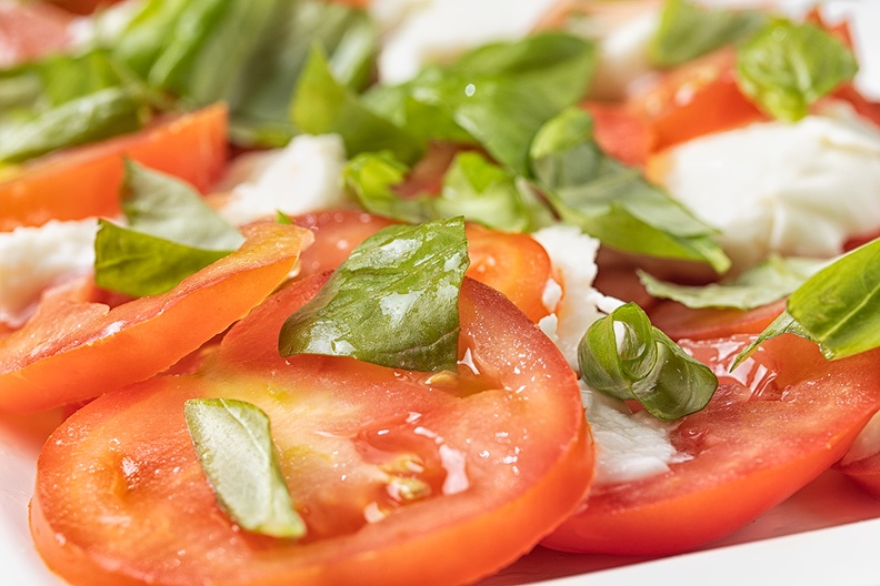 Homemade salad with tomatoes, mozzarella and basil.