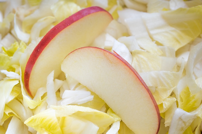 The making of a chicory-apple salad, served with baked potatoes and oven bag chicken