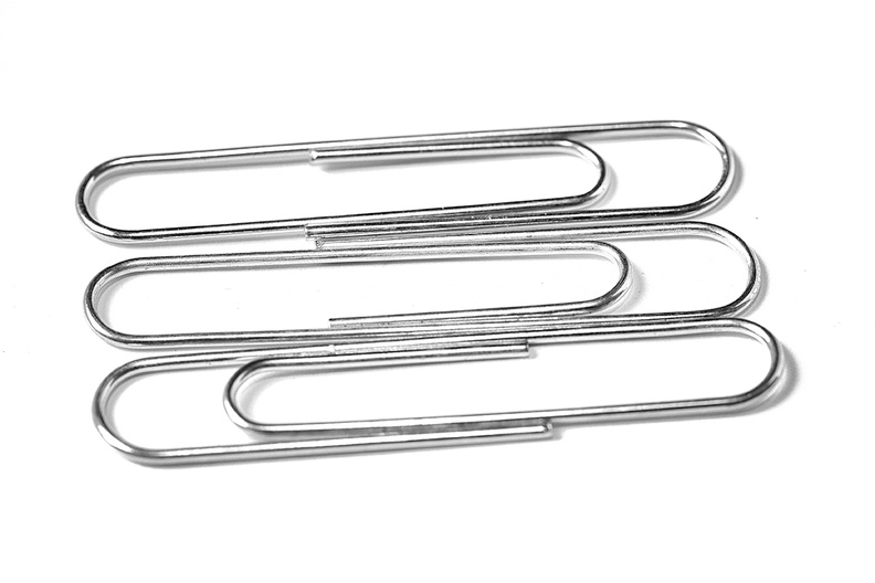Three paperclips on paper