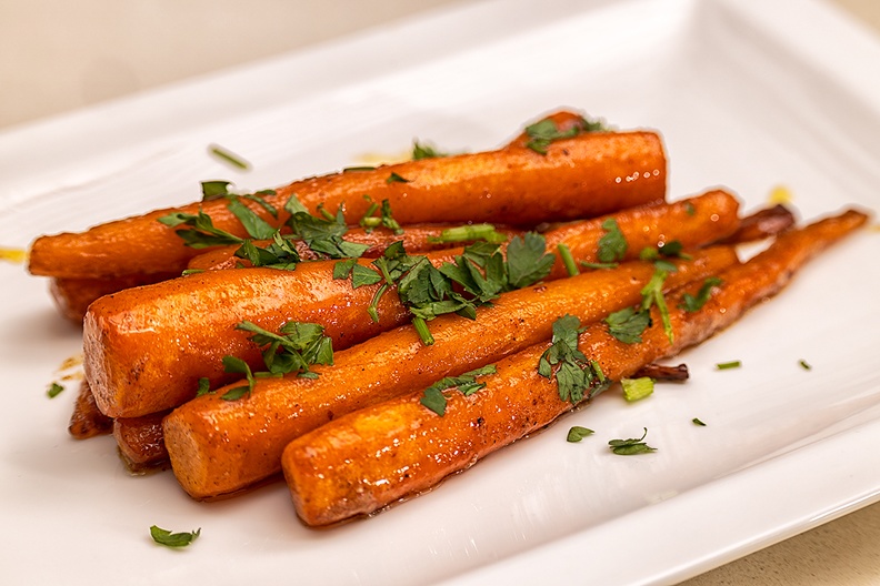 Baked carrots with honey. Served with potato gratin and pork tenderloin