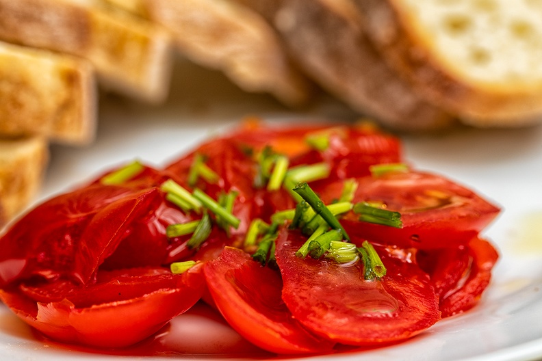 A simple tomato salad with chives, served with spare ribs