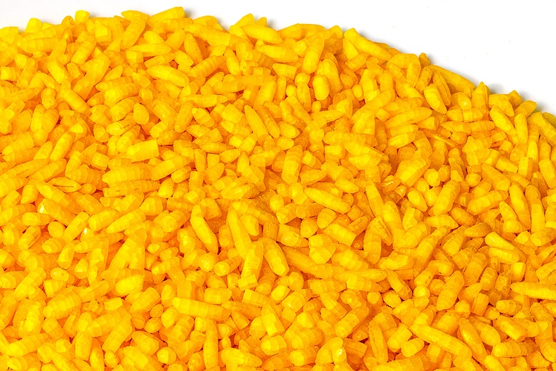 A plate with uncooked yellow rice