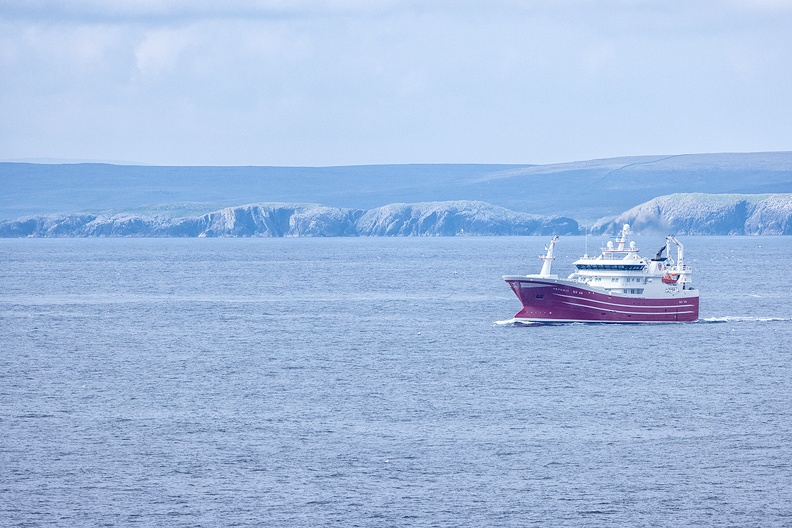 A boat with the beautiful Shetlands as background