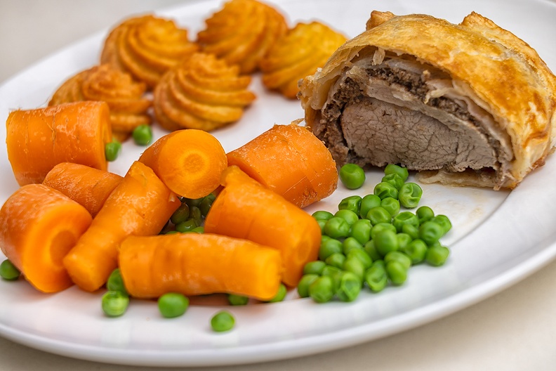 Pork tenderloin with mushroom puree and bacon, packed in puff pastry