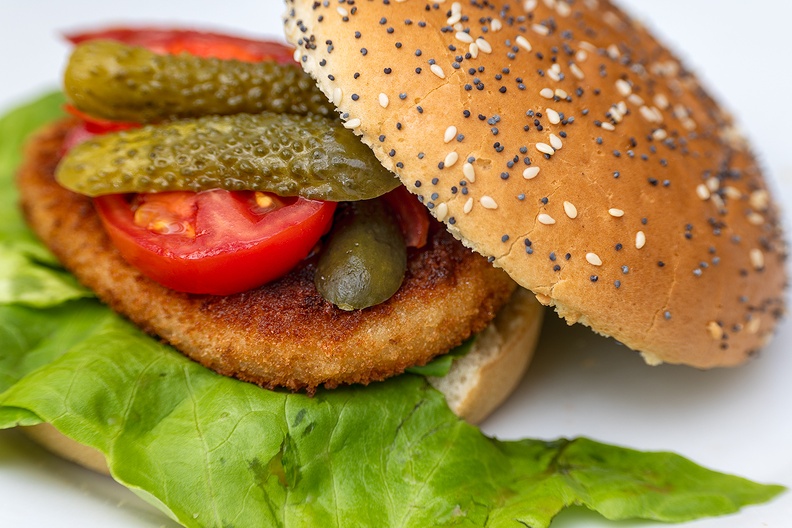 Cod burger with lettuce, tomato and pickle