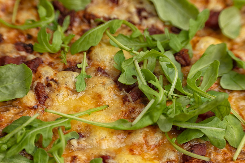 Flammkuchen with bacon, (gruyere) cheese and rocket